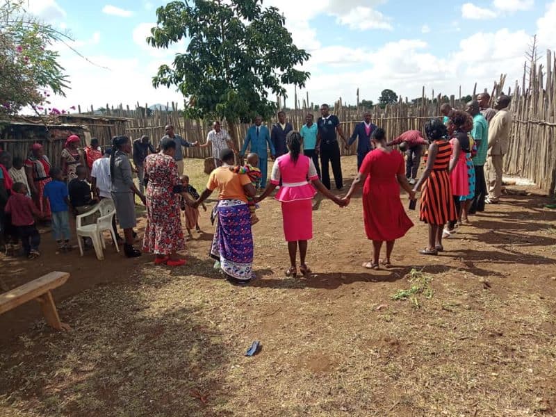 a group of people praying in Kenya