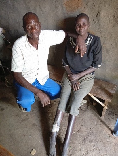 man sitting with DiDi on a bench in kenya
