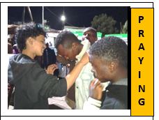 young men praying for another man